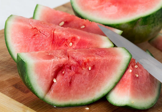 Slices of seedless watermelon with a knife blade