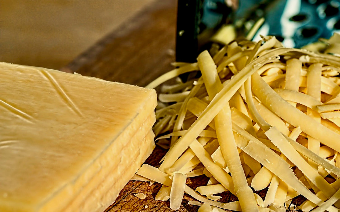Block of cheese and shreds of cheese